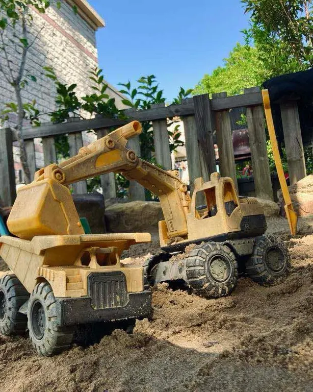 A toy digger in the Junior Kindy sandpit